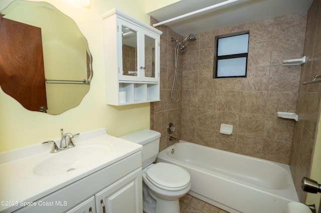 full bathroom with vanity, tile patterned flooring, tiled shower / bath, and toilet