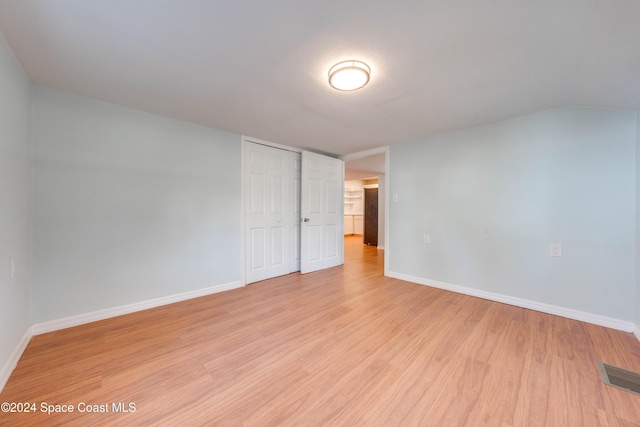 empty room with light hardwood / wood-style flooring