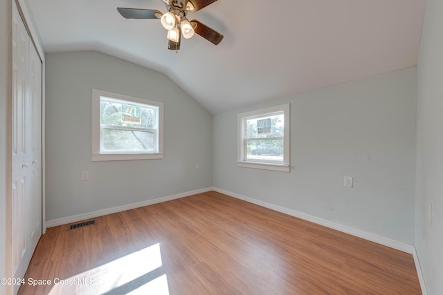 additional living space featuring plenty of natural light, light hardwood / wood-style floors, and lofted ceiling