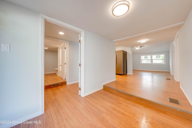 empty room featuring ceiling fan and light wood-type flooring