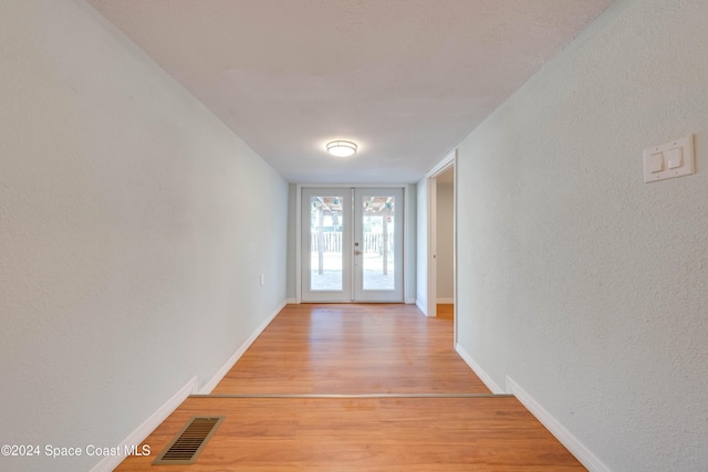 doorway with french doors and light hardwood / wood-style floors