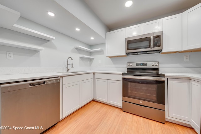 kitchen with white cabinetry, sink, and appliances with stainless steel finishes