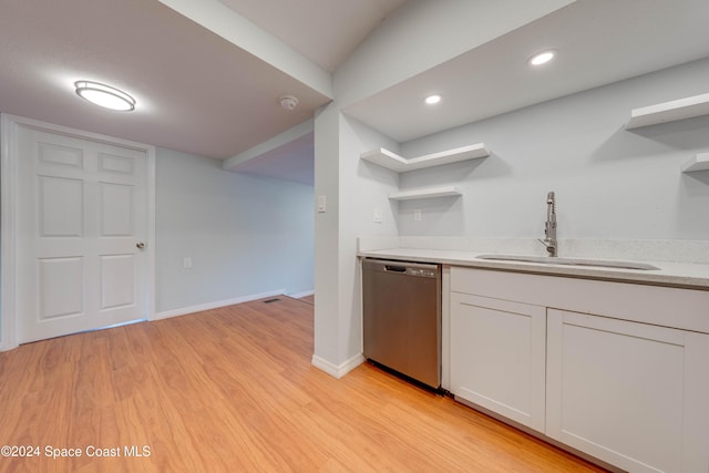 kitchen with white cabinetry, sink, stainless steel dishwasher, and light wood-type flooring