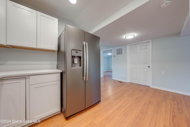 kitchen with white cabinetry, stainless steel fridge with ice dispenser, and light hardwood / wood-style flooring