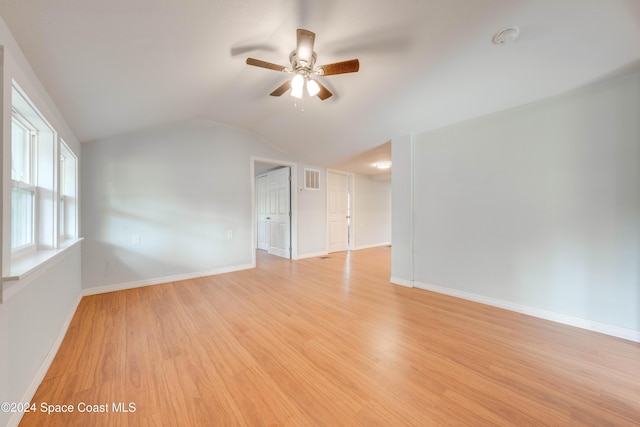 unfurnished room featuring light wood-type flooring, vaulted ceiling, and ceiling fan