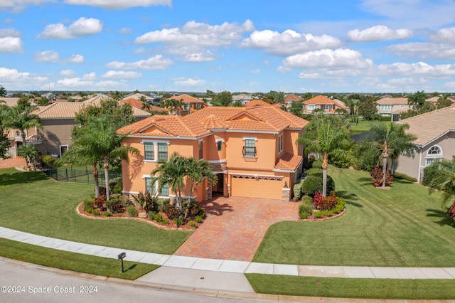 mediterranean / spanish-style house featuring a front lawn and a garage