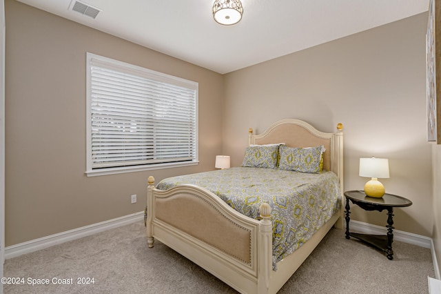 bedroom featuring light colored carpet