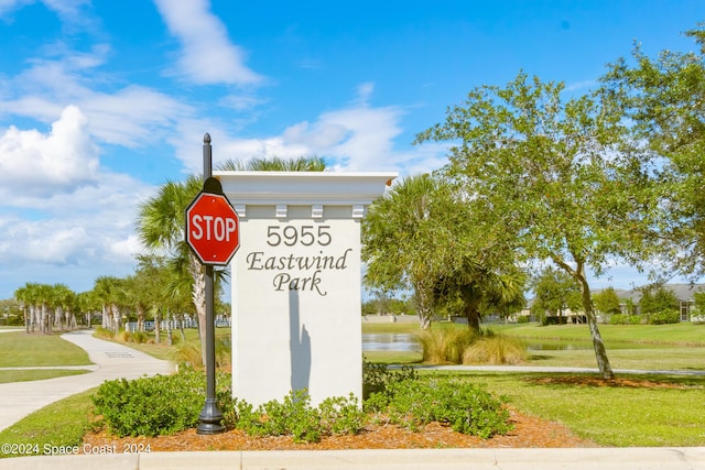 community sign featuring a water view