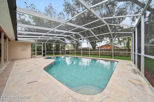 view of pool with a patio and a lanai