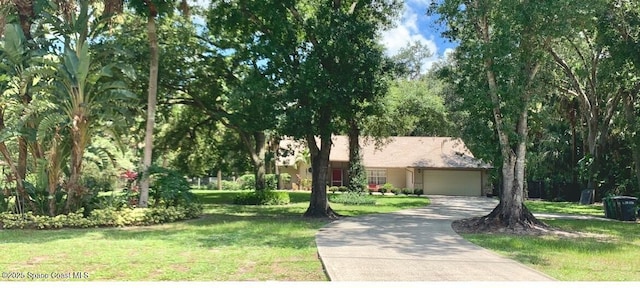 view of front facade with a garage and a front lawn