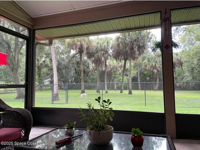 sunroom / solarium with plenty of natural light and vaulted ceiling