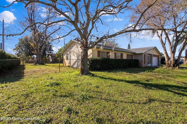 view of side of property featuring a lawn and a garage