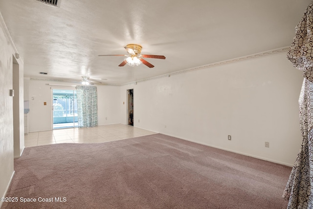 spare room with ceiling fan and light carpet