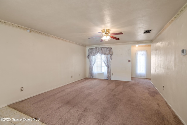 carpeted empty room featuring ceiling fan and ornamental molding