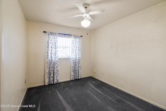 unfurnished room featuring dark carpet and ceiling fan