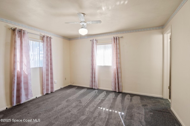 carpeted spare room with ceiling fan and crown molding