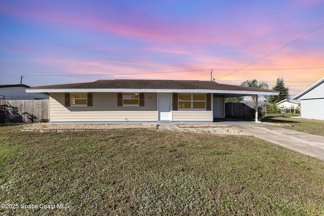 single story home featuring a carport and a yard