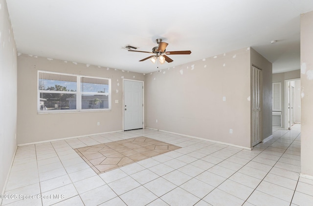 tiled empty room with ceiling fan