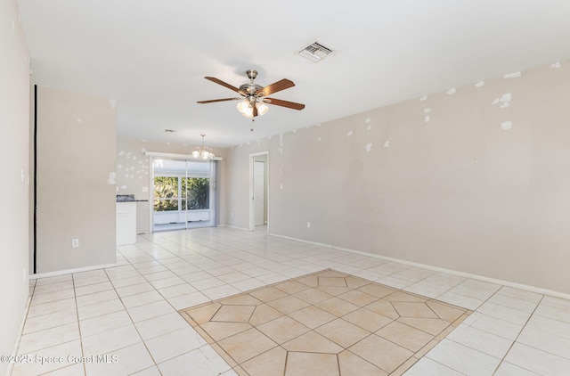 tiled spare room with ceiling fan