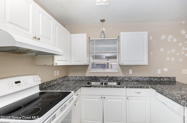 kitchen with sink, hanging light fixtures, dark stone counters, white appliances, and white cabinets