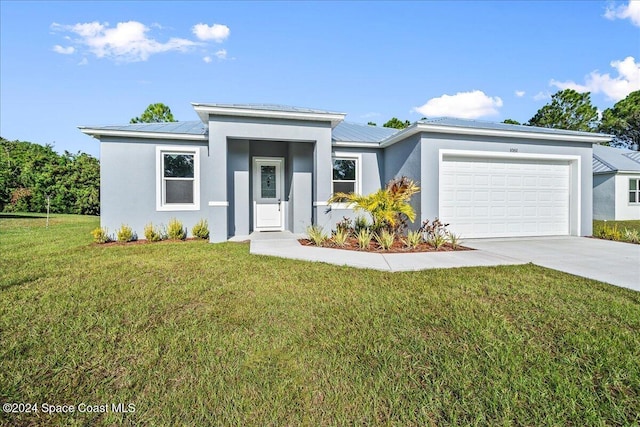 view of front of property featuring a garage and a front lawn