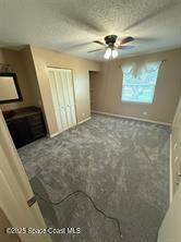 unfurnished bedroom with ceiling fan and carpet floors