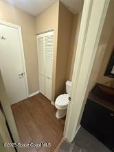 bathroom featuring hardwood / wood-style floors and toilet