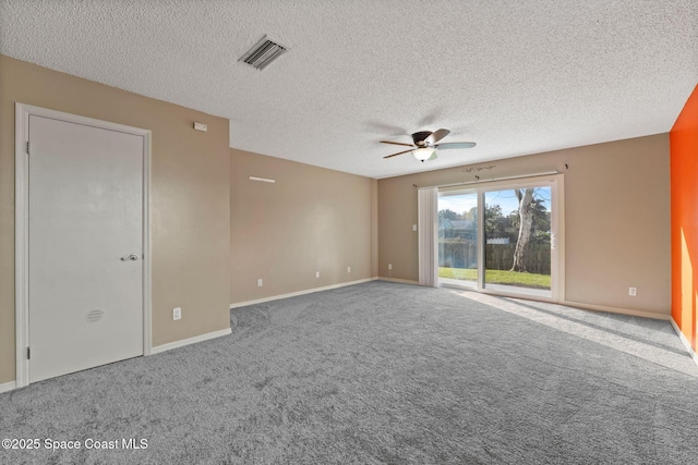 carpeted spare room with a textured ceiling and ceiling fan