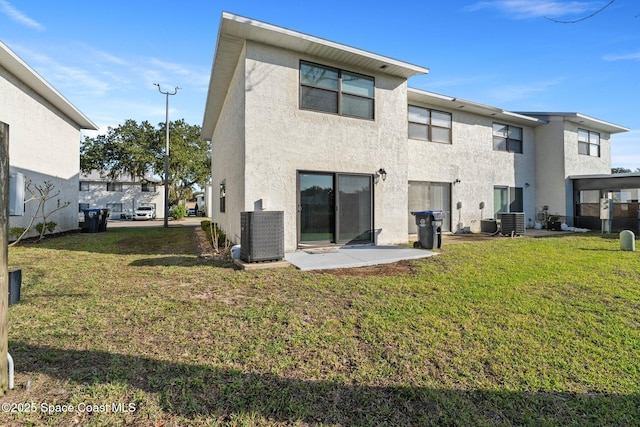 back of property with a yard, central AC, and a patio