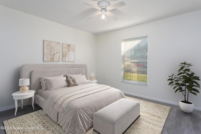 carpeted bedroom featuring multiple windows, ceiling fan, and a textured ceiling