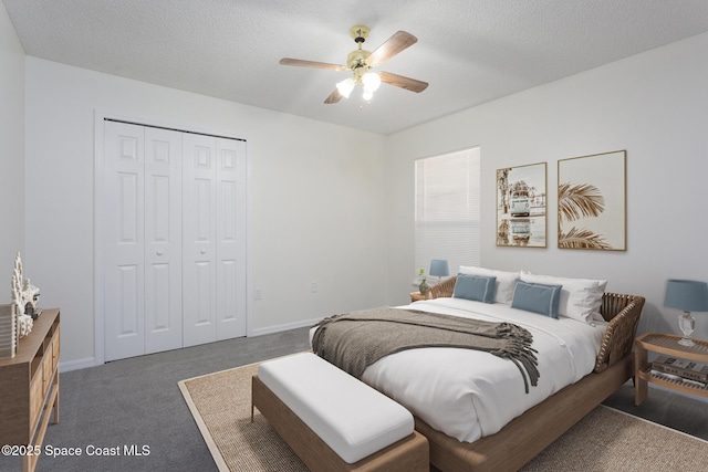 carpeted bedroom with a textured ceiling, a closet, and ceiling fan