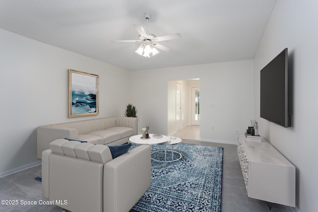 carpeted living room featuring ceiling fan