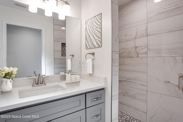 bathroom featuring vanity and a tile shower