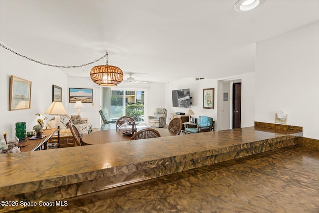 dining room featuring ceiling fan with notable chandelier