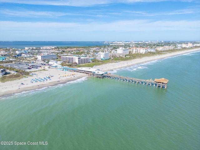 drone / aerial view featuring a view of the beach and a water view