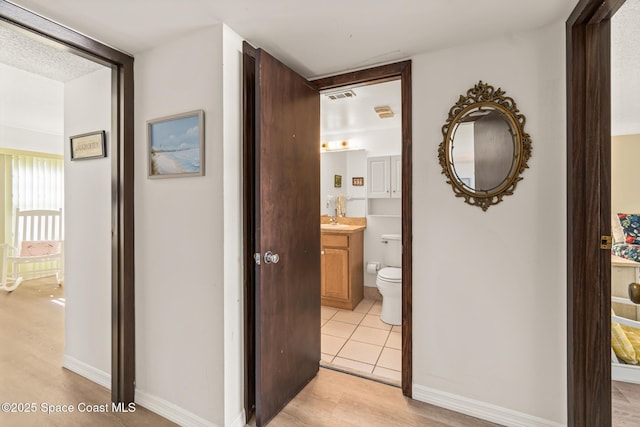 hallway with light tile patterned floors