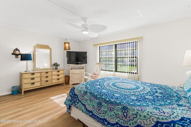 bedroom featuring a textured ceiling, hardwood / wood-style flooring, and ceiling fan