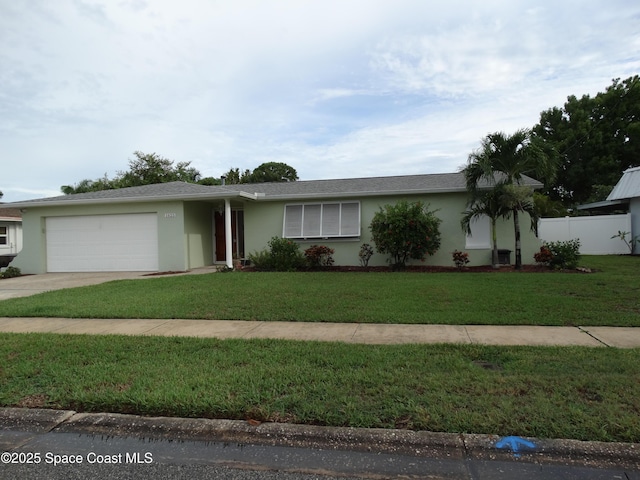 ranch-style home with a garage and a front yard