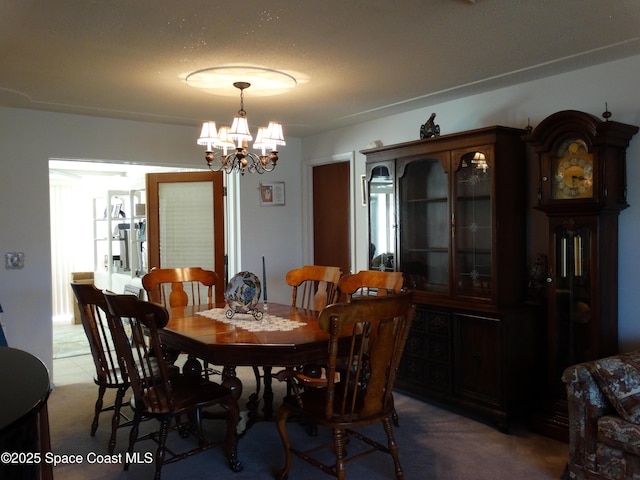 dining space with an inviting chandelier