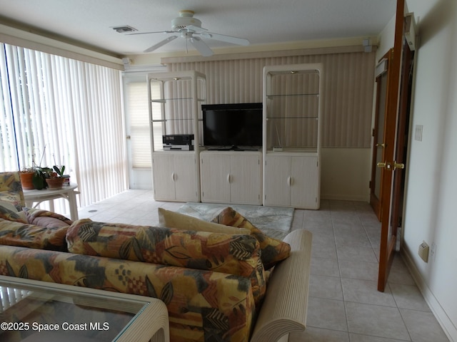 living room with ceiling fan and light tile patterned flooring