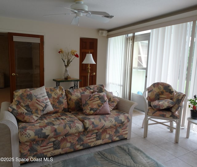 tiled living room with ceiling fan