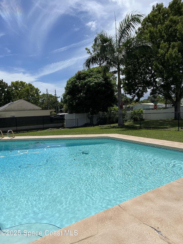 view of pool featuring a yard