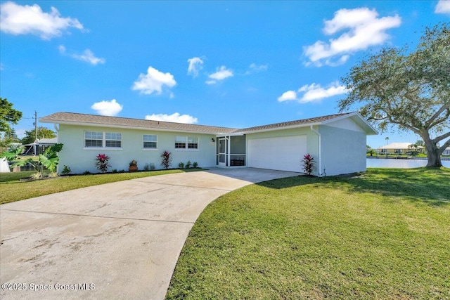 ranch-style house featuring a water view, a front yard, and a garage