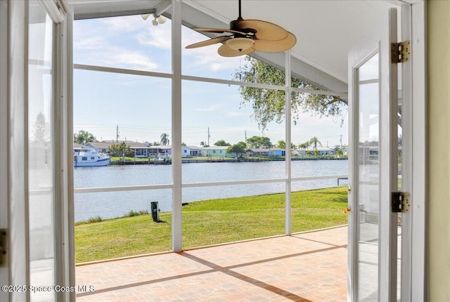 unfurnished sunroom with a wealth of natural light, a water view, and vaulted ceiling