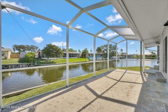 unfurnished sunroom with a water view