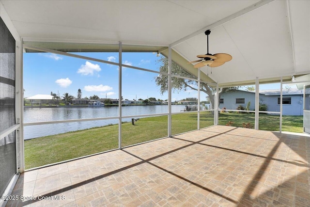 unfurnished sunroom with ceiling fan, a water view, and vaulted ceiling