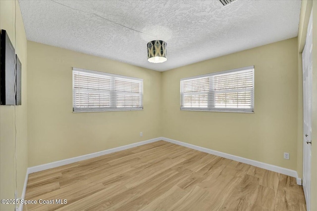 spare room featuring light hardwood / wood-style flooring