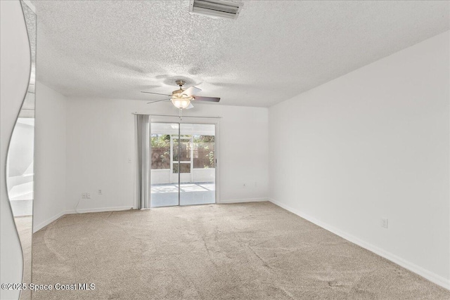 carpeted spare room with a textured ceiling and ceiling fan