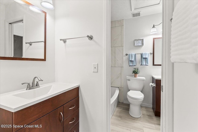 full bathroom featuring hardwood / wood-style floors, vanity, toilet, a textured ceiling, and shower / bathtub combination