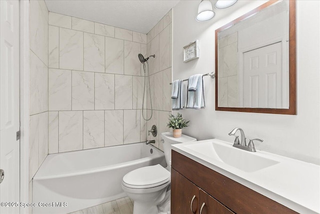 full bathroom with vanity, toilet, and tiled shower / bath